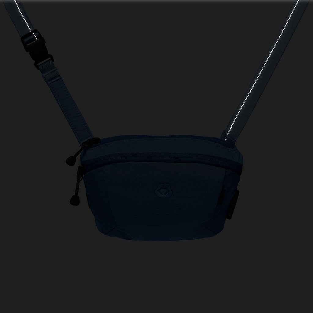 Black waist bag with a strap on a dark background