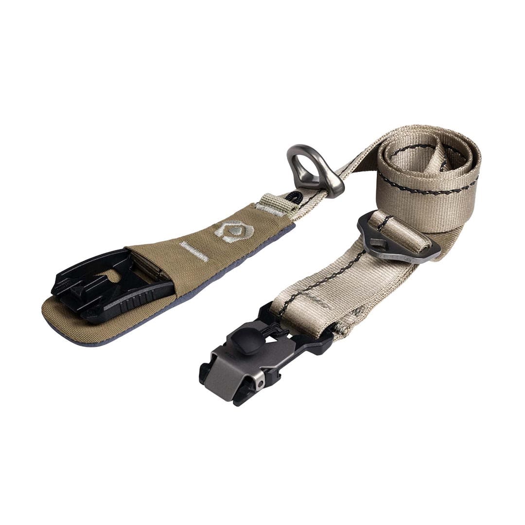 Tan strap with black plastic clip on a white background