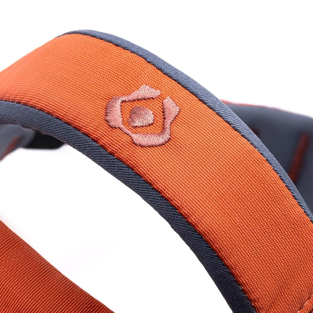 Close-up of an orange and gray strap with a pink embroidered logo on a white background