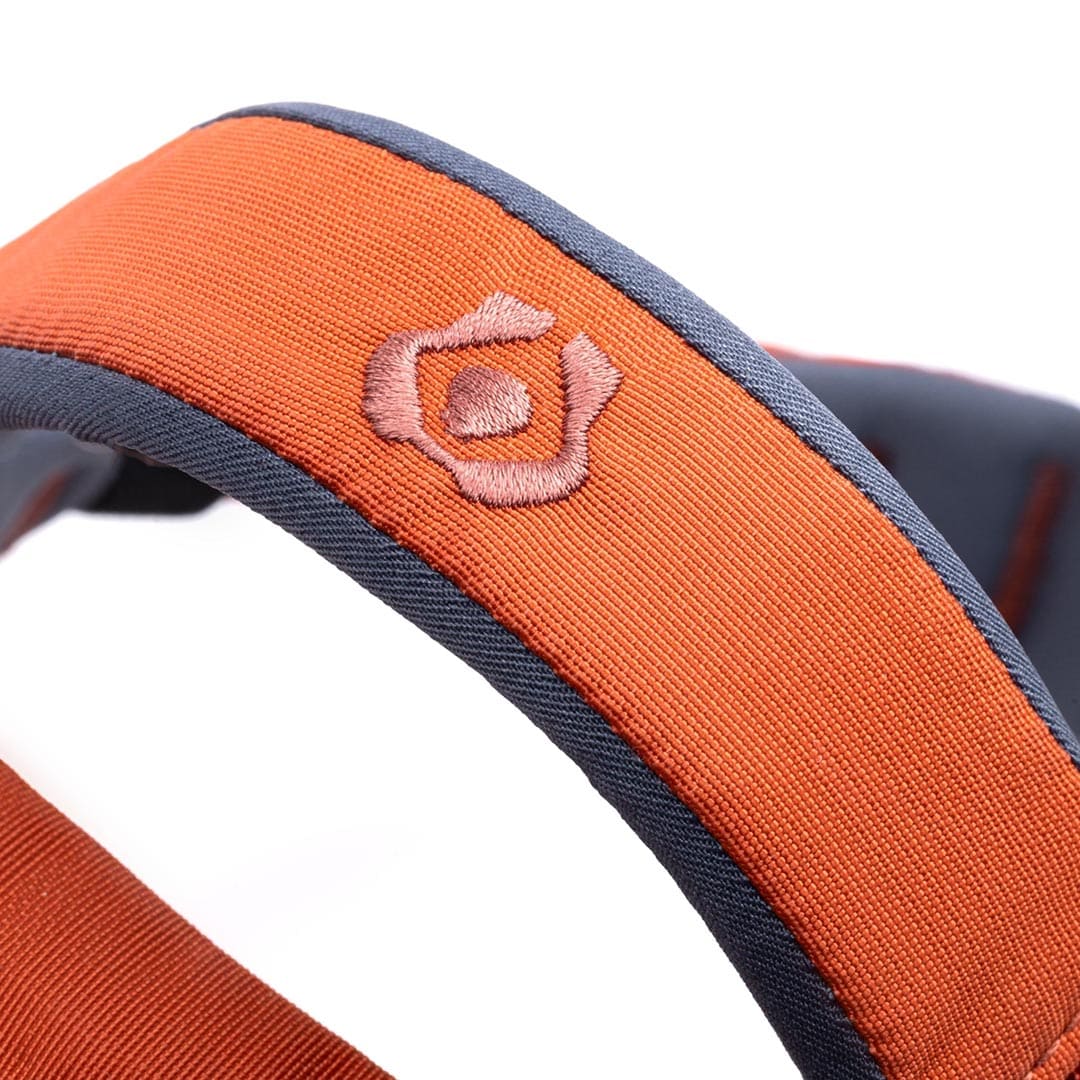 Close-up of an orange and gray strap with a pink embroidered logo on a white background