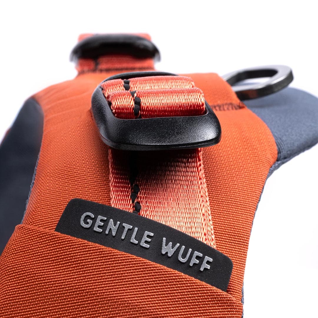 Orange dog harness with 'GENTLE WUFF' label on a white background