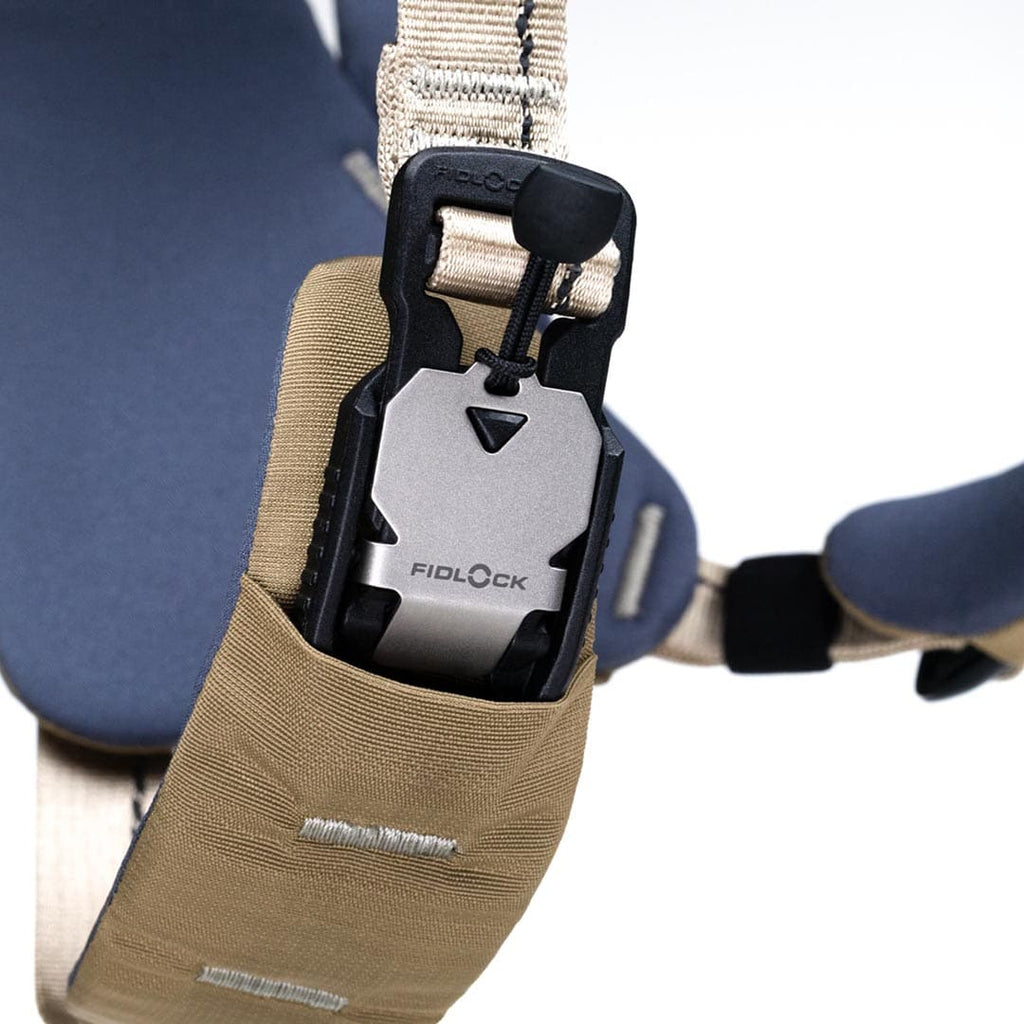 Close-up of a Fidlock lock mechanism on a strap with a beige pouch.