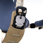 Close-up of a Fidlock lock mechanism on a strap with a beige pouch.