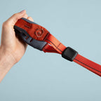 Hand holding a red quick grip against a light blue background