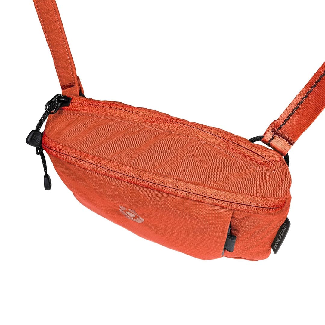 Orange waist bag with a strap on a white background