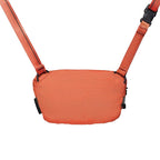 Orange crossbody bag with straps on a white background