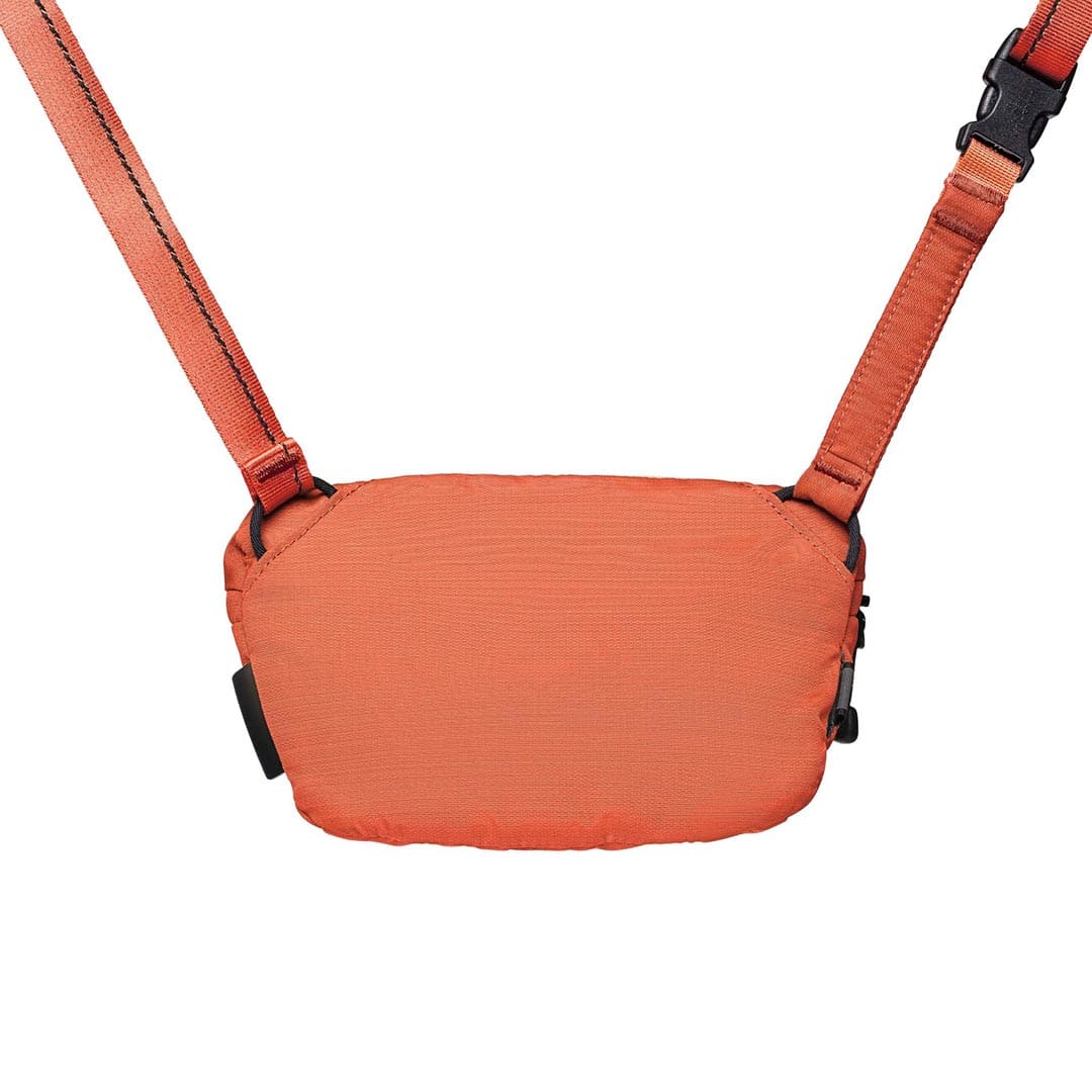 Orange crossbody bag with straps on a white background