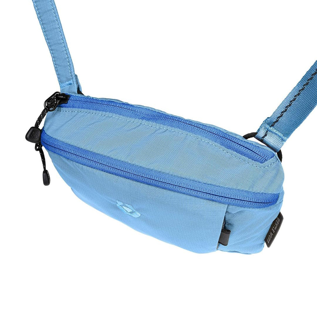 Light blue waist bag with a strap on a white background
