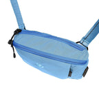 Light blue waist bag with a strap on a white background