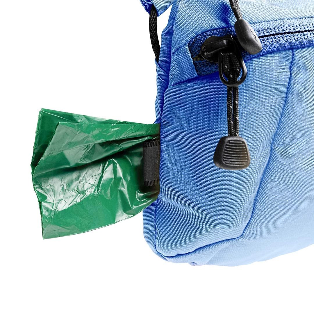 Blue backpack with a green trash bag attached to it on a white background