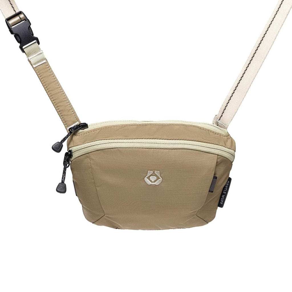 Beige crossbody bag with a visible brand logo on a white background
