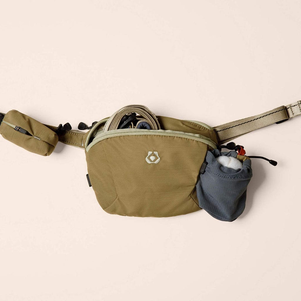 Khaki waist bag with small pouch on a beige background