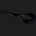 Black dog leash with reflective material on a black background