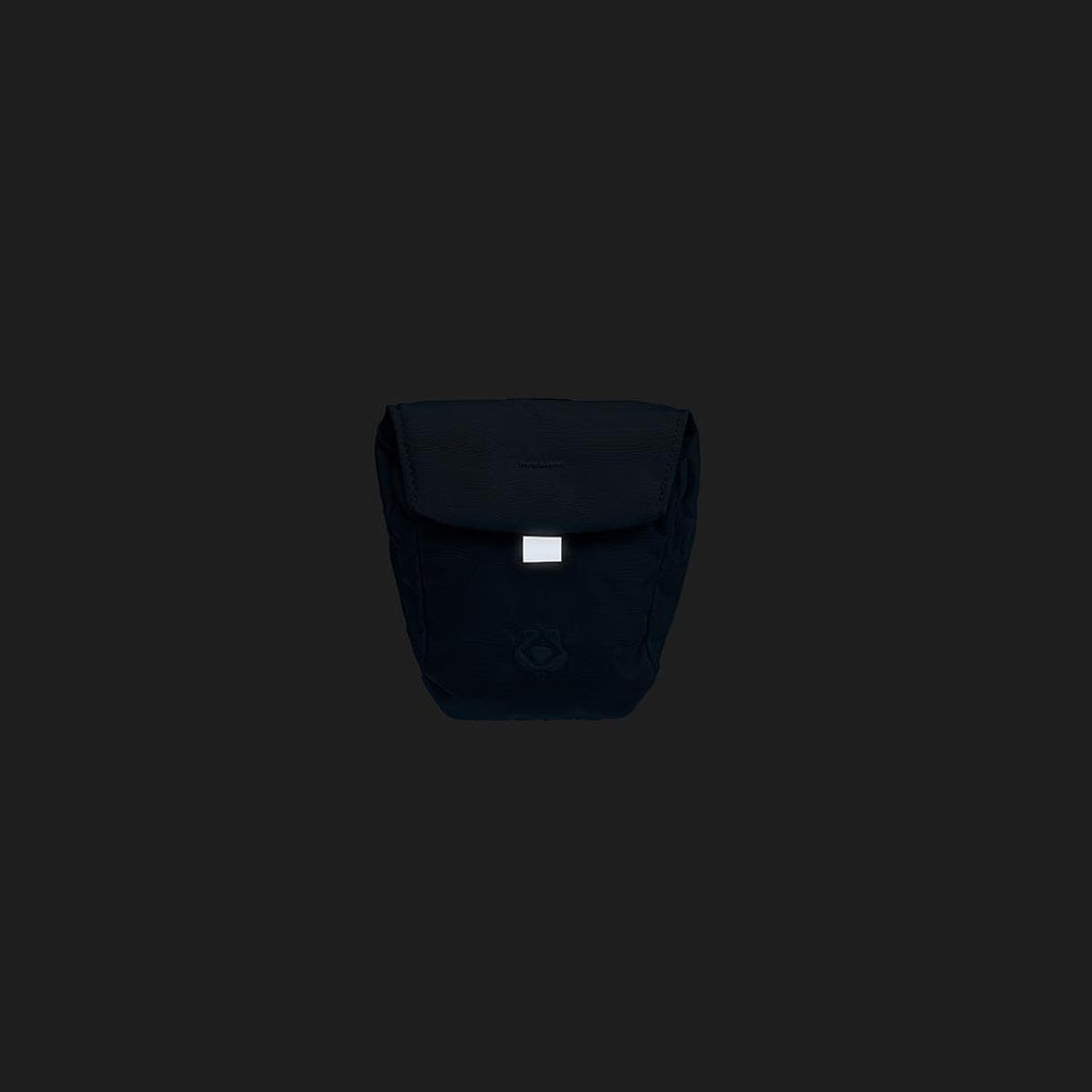 Black backpack with a visible brand logo on a black background