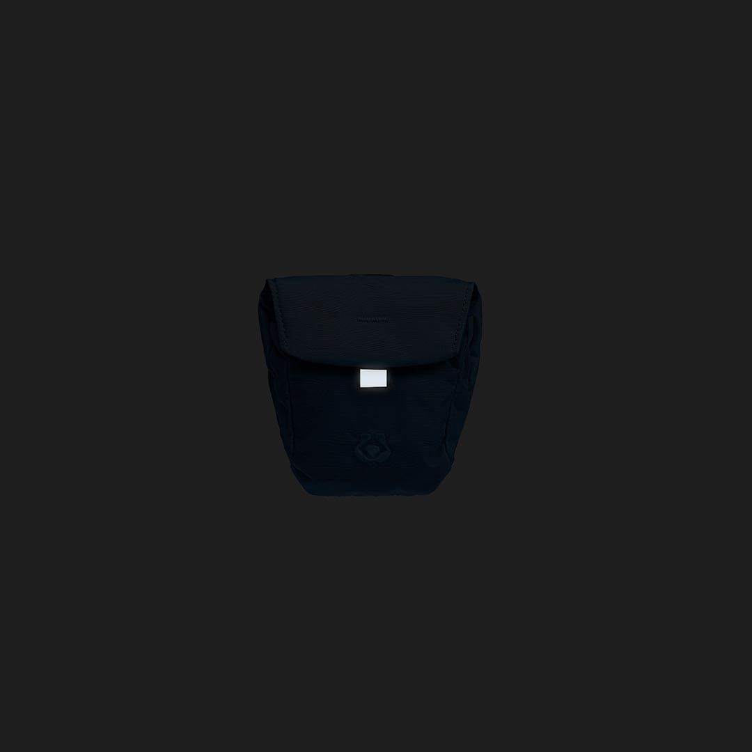 Black backpack with a visible brand logo on a black background