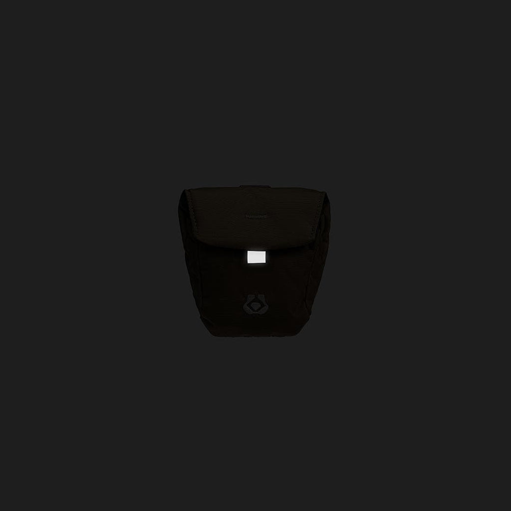 Black bag with a visible brand logo on a black background