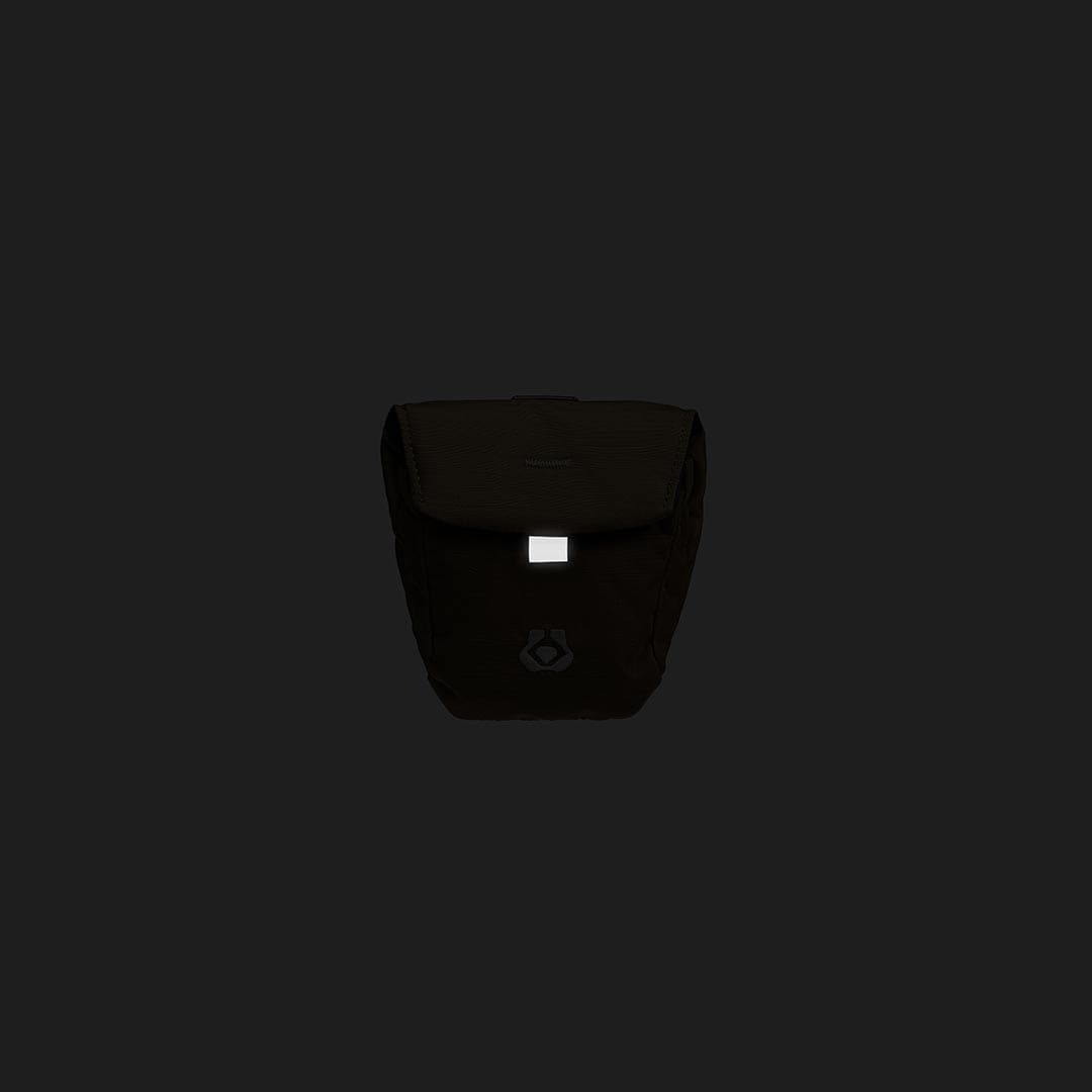 Black bag with a visible brand logo on a black background