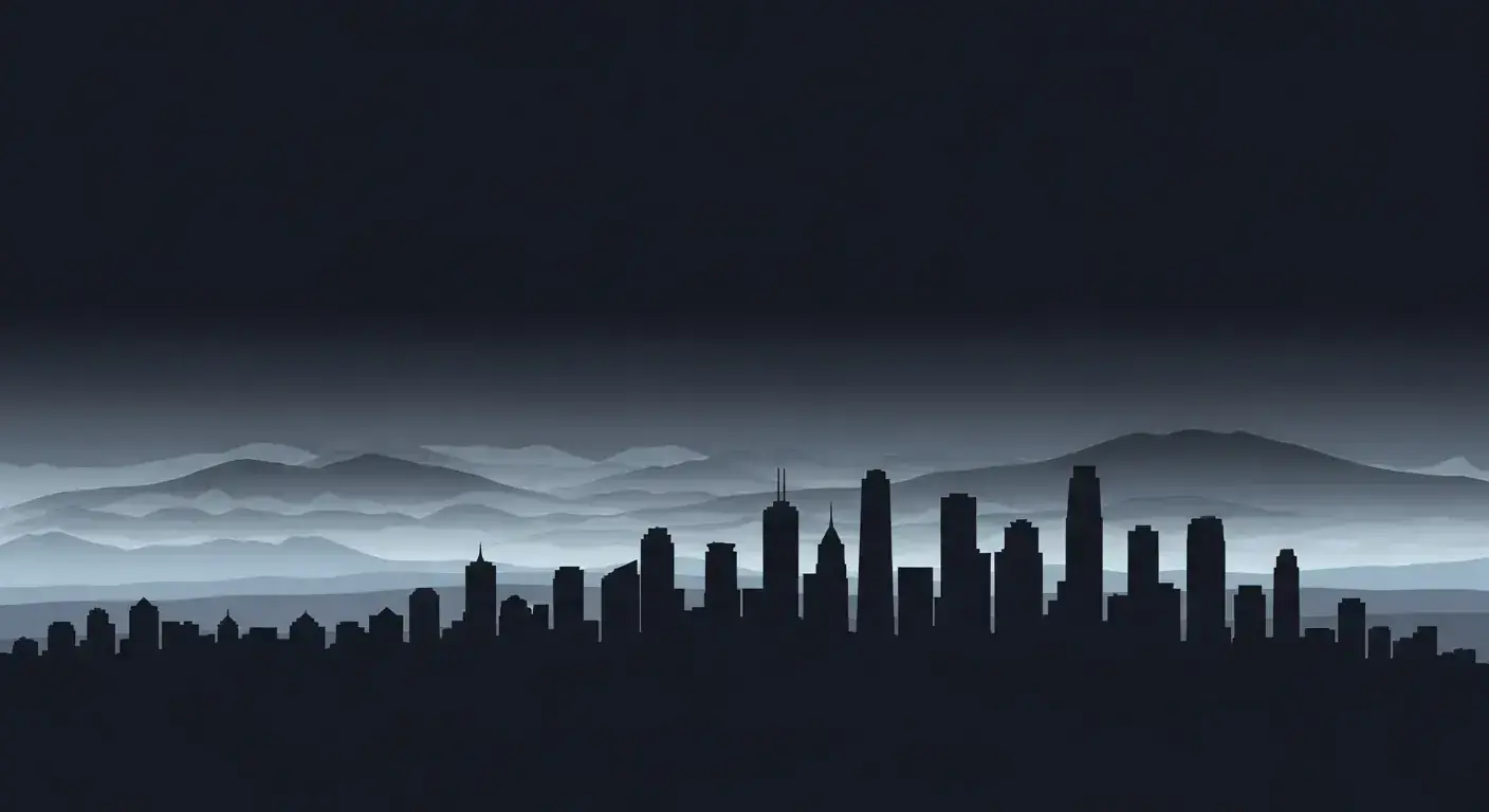 Layered silhouette of city skyscrapers with distant mountains
